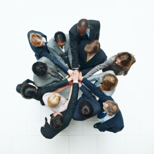Topview of businesspeople putting their hands together in together isolated on white